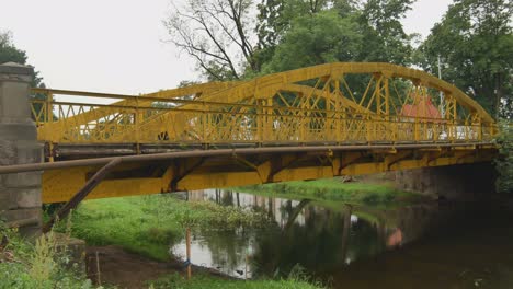 Yellow-Bridge-Over-the-Sysa-River-In-Silute,-Lithuania
