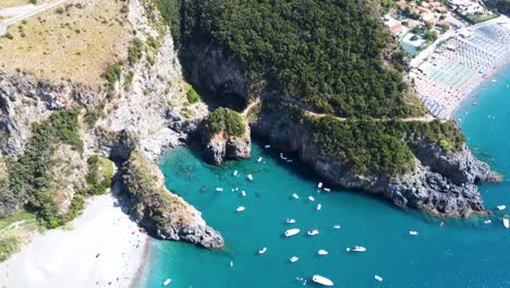 An-Italian-summer-around-Arcomagno,-San-Nicola-Arcella-on-a-sunny-day-and-turquoise-water-filled-with-boats