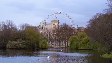 London-Eye-from-St-James's-Park-with-Union-Jack-flying-at-half-mast-to-mark-the-death-of-Prince-Philip,-Duke-of-Edinburgh,-Saturday-April-10th,-2021---London-UK