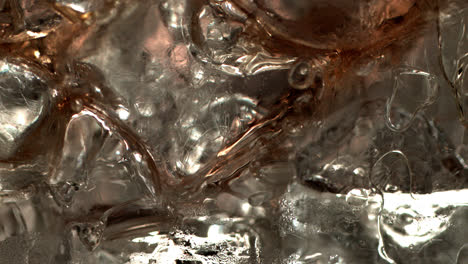 Pouring-coke-on-ice-cubes-extreme-close-up
