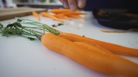 Hand-picking-up-carrot-in-kitchen