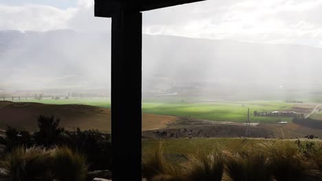 Sun-breaking-through-rain-mist-overlooking-valley-of-mountains
