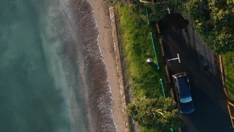 Birds-eye-aerial-footage-over-a-New-Zealand-shore-with-blue-ocean-waters-1