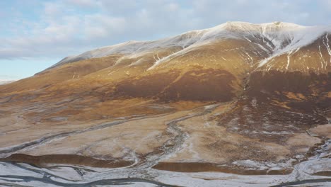 Glacial-Rivers-Flow-Below-Fantastic-Snow-Capped-Mountains-in-the-icy-Westfjords,-Iceland,-Drone-Aerial,-reykjavik-winter