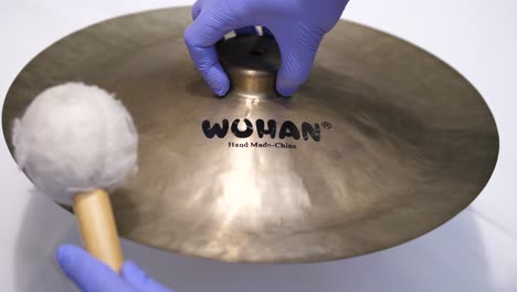 Hand-made-Wuhan-China-cymbal-hit-with-a-soft-mallet,-coronavirus-alarm
