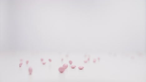 Rose-pills-falling-on-white-background-in-slow-motion