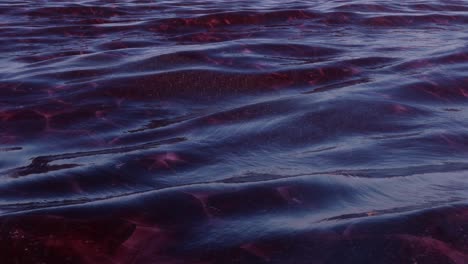 Abstract-obsidian-red-deep-dark-blue-ocean-waves,-tranquil-gentle-rolling-motion-seamless-looping