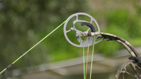 A-slow-motion-shot-of-the-top-Cam-of-a-compound-bow-as-the-bow-is-drawn-and-released