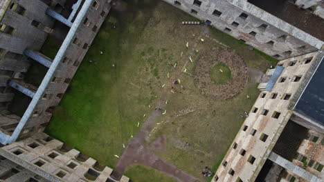People-In-The-Old-Ruin-Of-Borgholm-Castle-In-Oland,-Sweden---top-down-shot,-aerial-drone-ascend