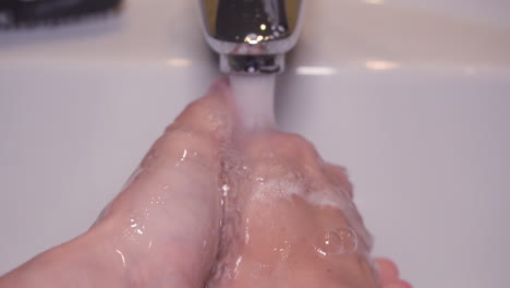 Close-up-slow-motion-Man-washing-male-hand-with-soap-and-water