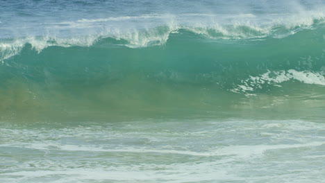 Blaue-Grüne-Welle,-Die-In-Zeitlupe-Auf-Das-Ufer-Trifft-Und-Abstürzt