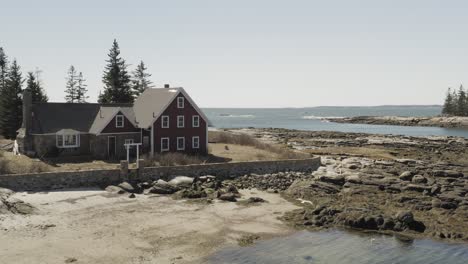 Seaguls-flying-around-an-island-home-off-the-coast-of-maine-AERAIL