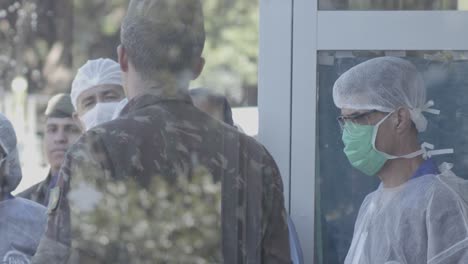 Doctors,-nurses-and-surgeons-wait-outside-of-a-contaminated-hospital-with-the-Brazilian-military