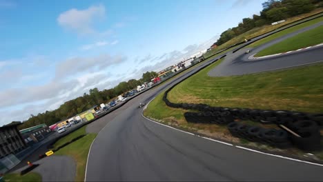 Karting-passing-finish-line-while-chased-by-FPV-drone