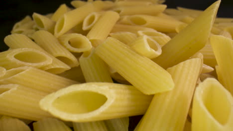 Macro-slide-across-a-bunch-of-uncooked-penne-pasta