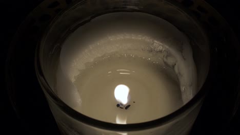 Close-Up-Of-Candle-Holder-With-Single-Flame-And-Melted-Wax-Locked-Off