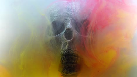 Slowmotion-movement-around-the-human-skull-of-fog-made-from-different-colored-powders