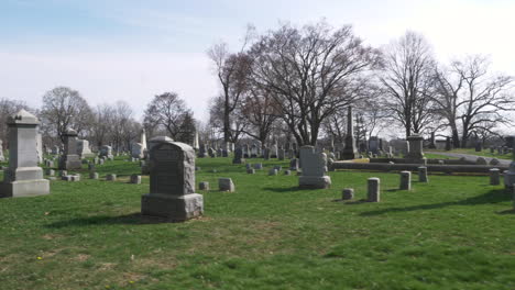 SLOW-MOTION-:-Driving-slowly-by-rows-of-old-headstones-through-a-cemetery-on-a-beautiful-day