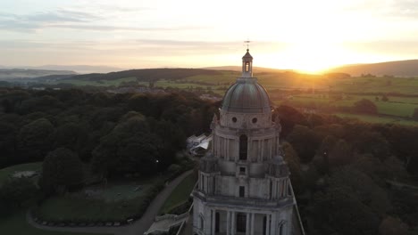 Historic-Ashton-memorial-English-grand-dome-landmark-Lancashire-countryside-sunrise-Aerial-left-orbit-view