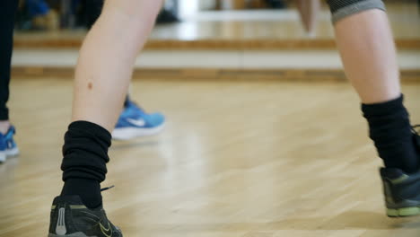 Low-angle-close-up-of-feet-during-group-exercise