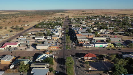 Aerial:-Drone-shot-slowly-moving-forwards-over-the-high-street-in-Winton,-QLD-Australia