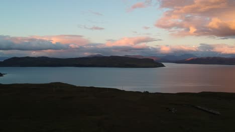 Golden-hour-panning-drone-shot-of-Scottish-mountain-lake