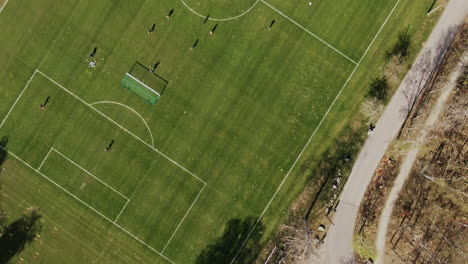 Drone-shot-facing-down-on-soccer-training-grounds-on-sunny-spring-day