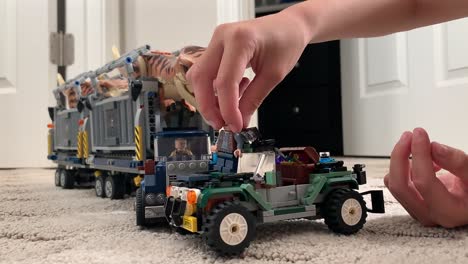 Small-hands-playing-with-Jurassic-World-Lego-toys