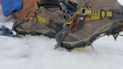 Boots-with-Crampons-Stepping-on-an-Icy-Glacier,-Close-Up-Slow-Motion