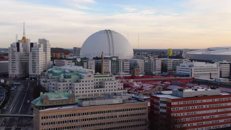 Drone-descent-covering-Ericsson-Globe-at-medium-distance-on-sunny-day