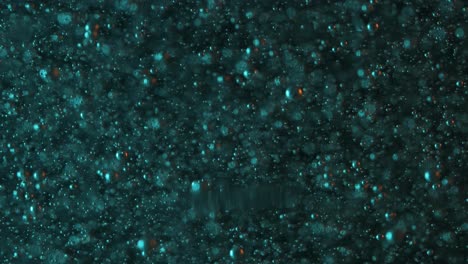 Slow-orange-and-teal-bubbles-rising-against-a-dark-background
