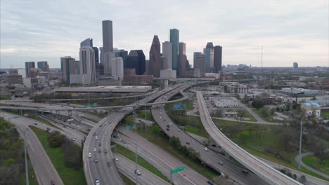 Aerial-view-of-traffic-on-freeway-near-downtown-Houston-on-a-cloudy-day-during-sunset
