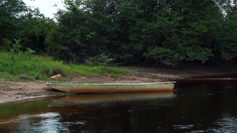 An-old-wooden-row-boat-docked-at-the