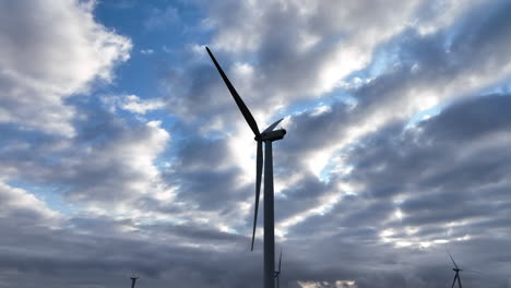 Blue-sky-and-clouds-over-stopped-wind-turbine