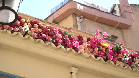 Vintage-building-with-pink-and-red-flowers-on