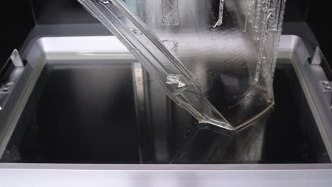 View-of-a-Resin-Tank-Within-a-3D-Printer-While-Curing-a-Layer-with-UV-Light-of-a-Part-Produced-with-Clear-Resin-for-the-Automotive-Industry