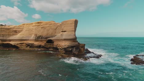 4k-Aerial-Big-rock-with-an-arch-in-the-ocean-near-coast