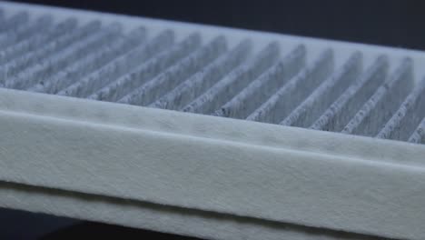 Close-Up-Of-A-Carbon-Charcoal-Cabin-Car-Air-Filter-Rotating-In-The-Dark