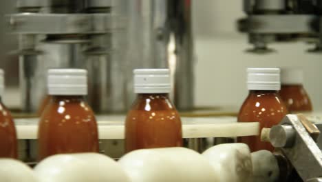 Syrup-bottle-in-assembly-line-moving-full-from