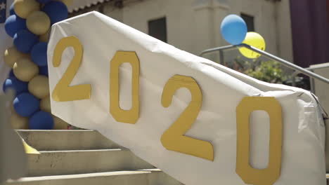 2020-Celebration-Sign-with-Balloons-on-School-Front-Steps,-Slow-Motion