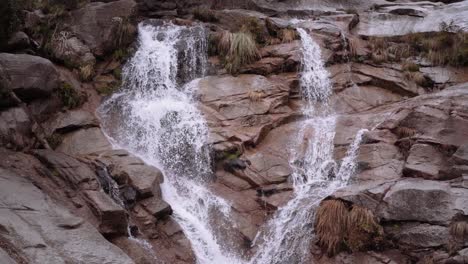 Medium-Wide-Jib-Down-Slow-Motion-Shot-of-Waterfall-Stream-to-Pond