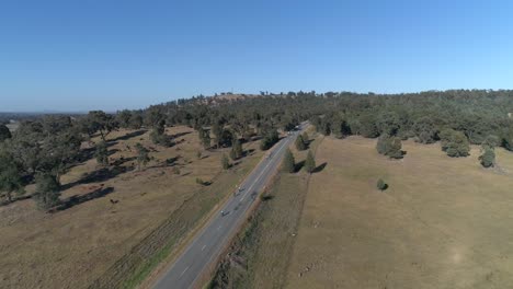 Aerial-view-of-cyclists-taking-on-a-hill-climb-in-the-popular-Gears-and-Beers-race-held-in-the-rural-city-of-Wagga-Wagga-NSW-Australia-surrounded-by-beautiful-country-landscape