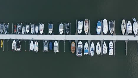 Top-down-aerial-view-of-boats-along-dock-in-Helsinki,-Finland