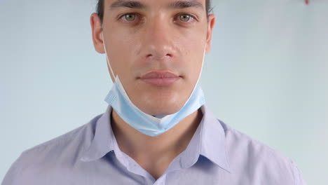 Slow-motion-of-a-Young-Man-Wearing-a-Face-Mask-Below-Chin,-Closeup