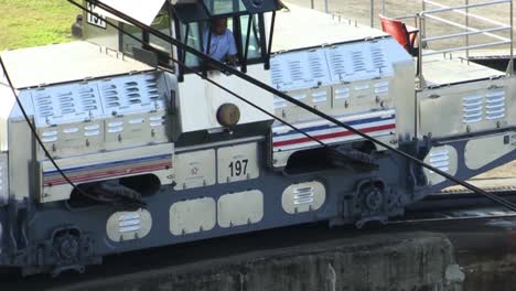 Closeup-frame-of-the-locomotive-while-is-pulling-the-ship-thru-the-flooded-chamber-of-the-Gatun-locks,Panama-canal