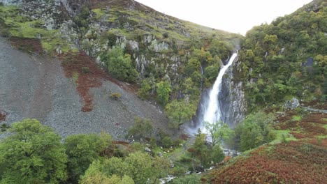 Idyllic-Snowdonia-mountain-range-Aber-falls-waterfalls-national-park-aerial-static-view