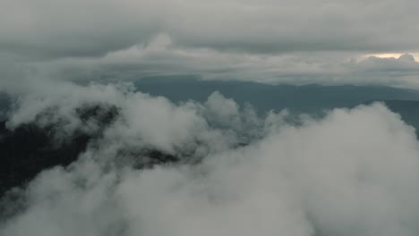 drone-aerial-shot-flying-over-clouds-in-a-beautiful-misty-day,-top-of-a-cloud-forest-in-Guatemala