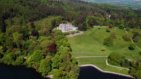 Beautiful-drone-shot-of-Castlewellan-Castel-coming-over-Castlewellan-lake