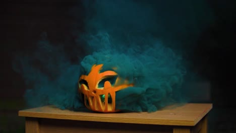 Super-thick-colourful-vivid-dark-blue-smoke-coming-out-of-the-carved-pumpkin-in-slow-motion