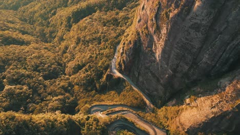 Aerial-view-of-one-of-the-most-beautiful-and-dangerous-rainforest-mountain-roads-in-the-world,-Serra-Do-Corvo-Branco,-Grão-Pará,-Santa-Catarina,-Brazil